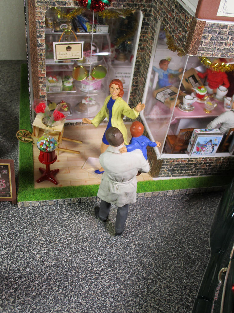 Papa, mama and a boy at pastry shop